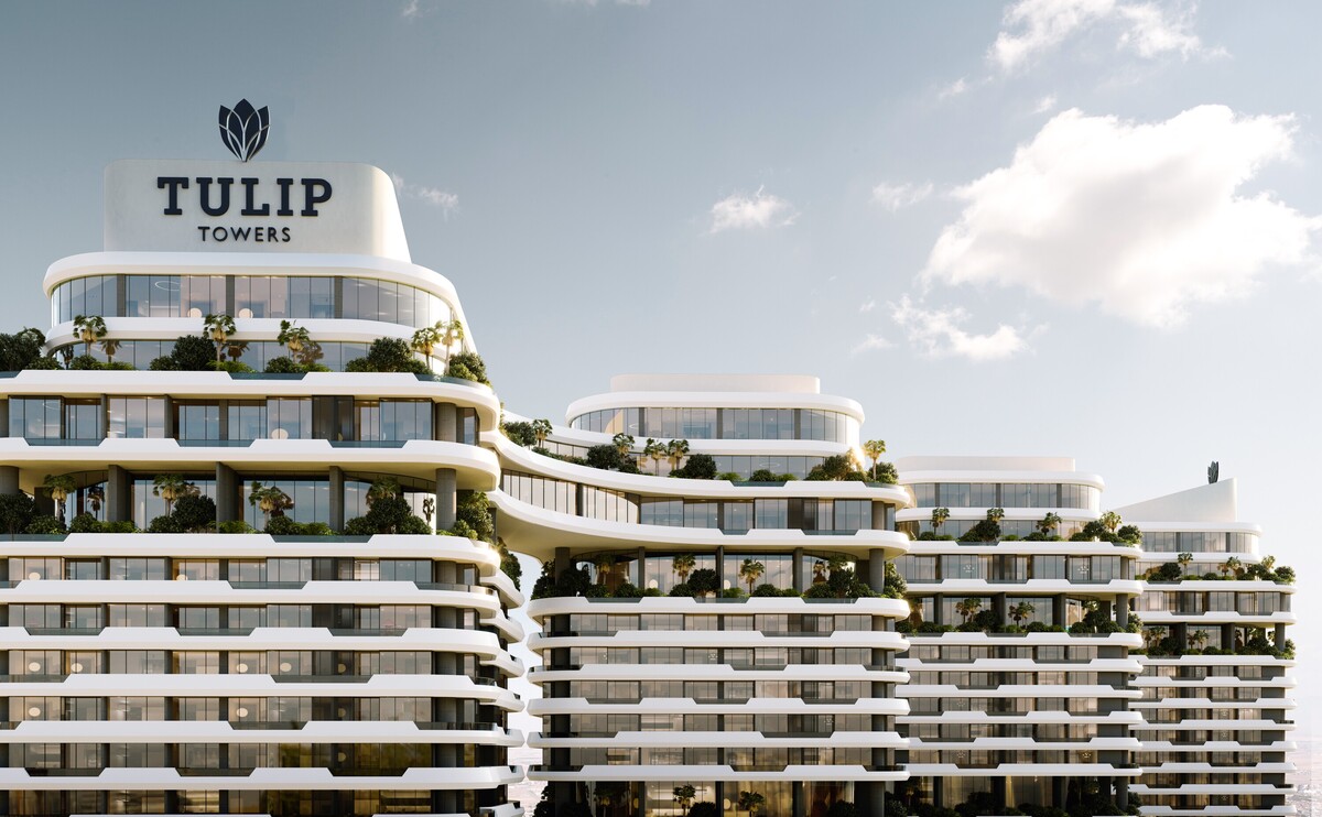 Close-up view of the Tulip Towers development showcasing its distinctive curved balconies, landscaped terraces, and contemporary architectural design. The image highlights the project’s signature façade and premium residential character.