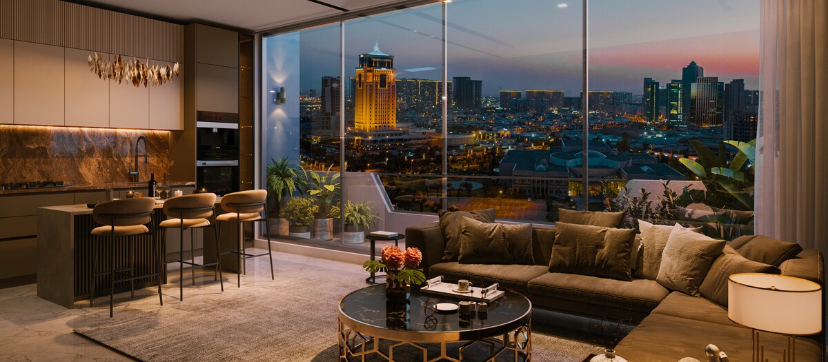 Modern open-plan living room and kitchen at Tulip Towers with floor-to-ceiling windows overlooking the illuminated city skyline of Erbil. The image showcases contemporary interior design, premium finishes, and panoramic urban views.