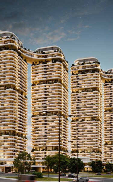 Exterior view of the Tulip Towers residential development featuring four modern high-rise buildings with distinctive curved balconies. The image highlights the project’s contemporary architecture and illuminated facade at dusk.
