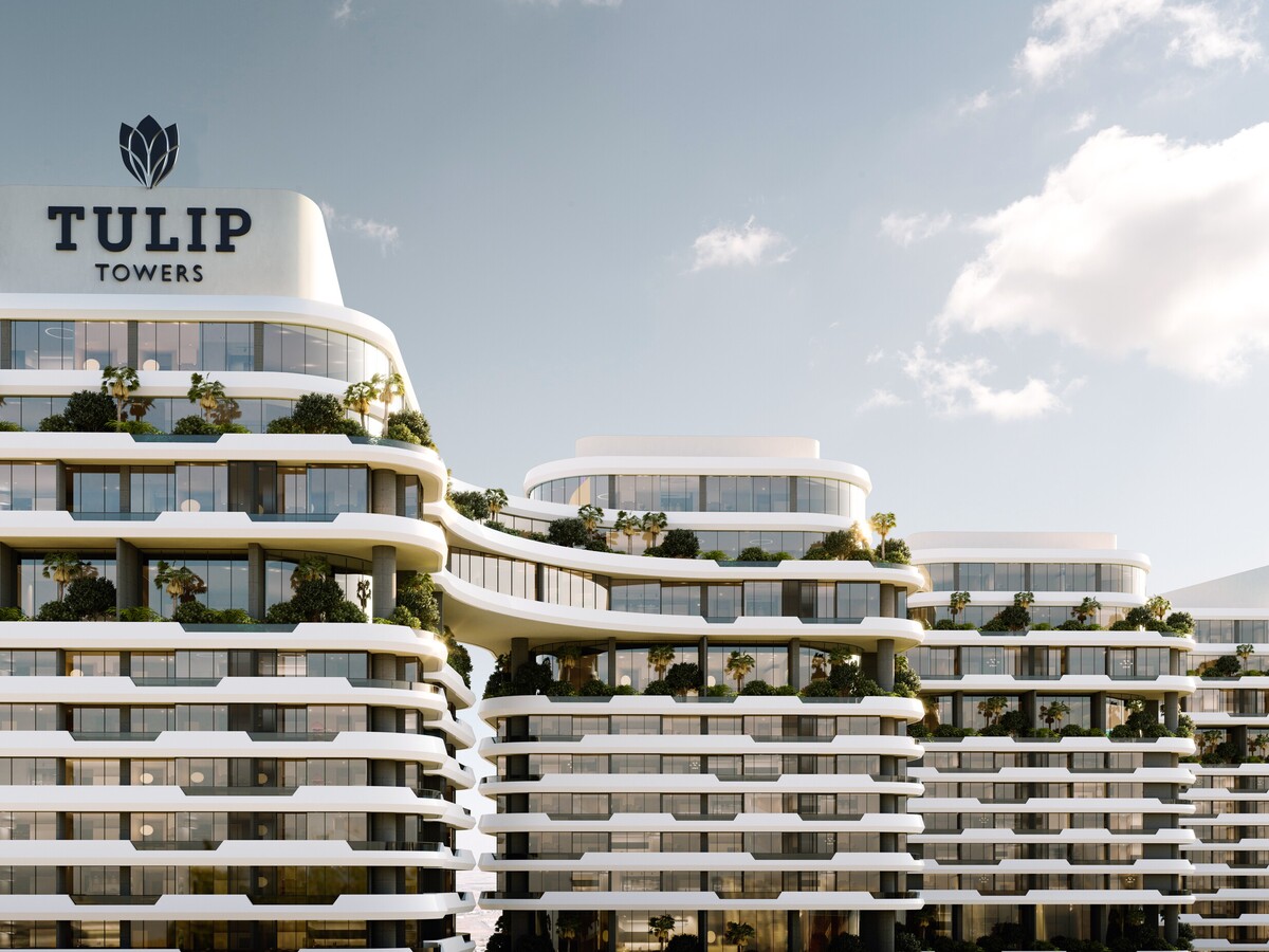 Close-up view of the Tulip Towers development showcasing its distinctive curved balconies, landscaped terraces, and contemporary architectural design. The image highlights the project’s signature façade and premium residential character.
